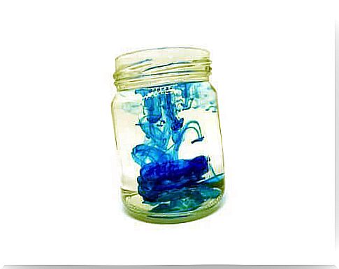 Glass with water and blue food coloring