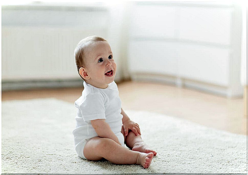 Happy baby sitting on the floor