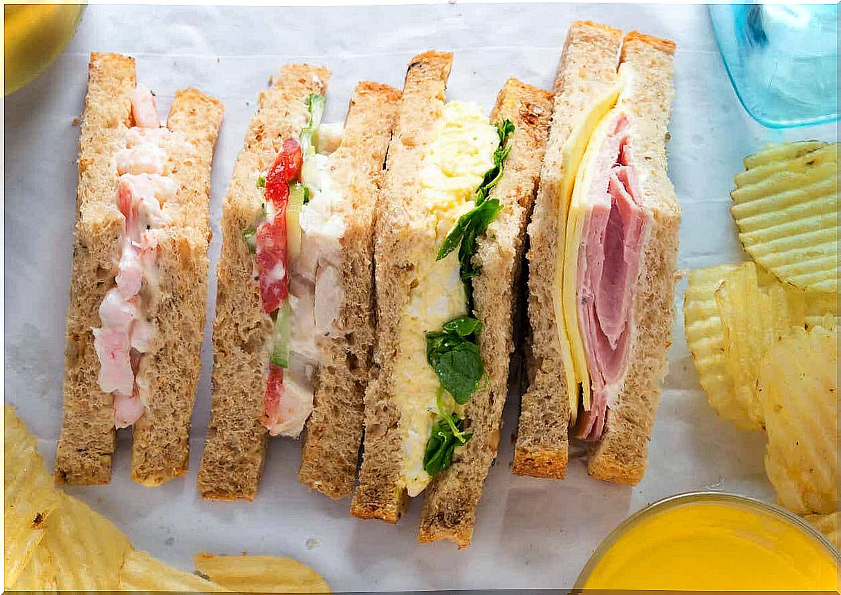 Sandwiches cut into triangle-shaped quarters.