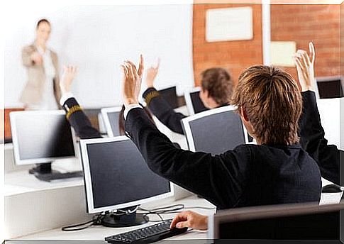 Students in class raise their hands