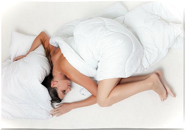 Sleeping mother with a white duvet