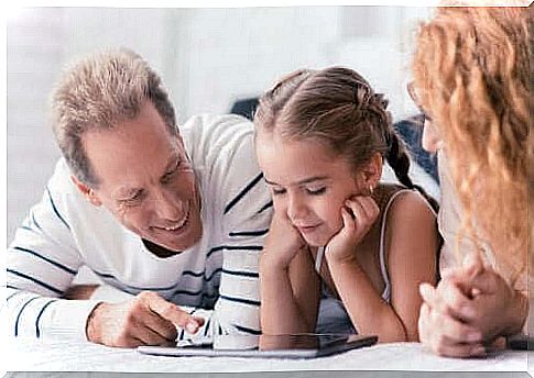 Parents and daughter on a tablet