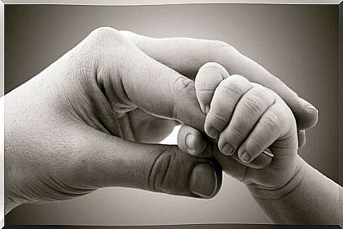 Baby grabs mommy's finger