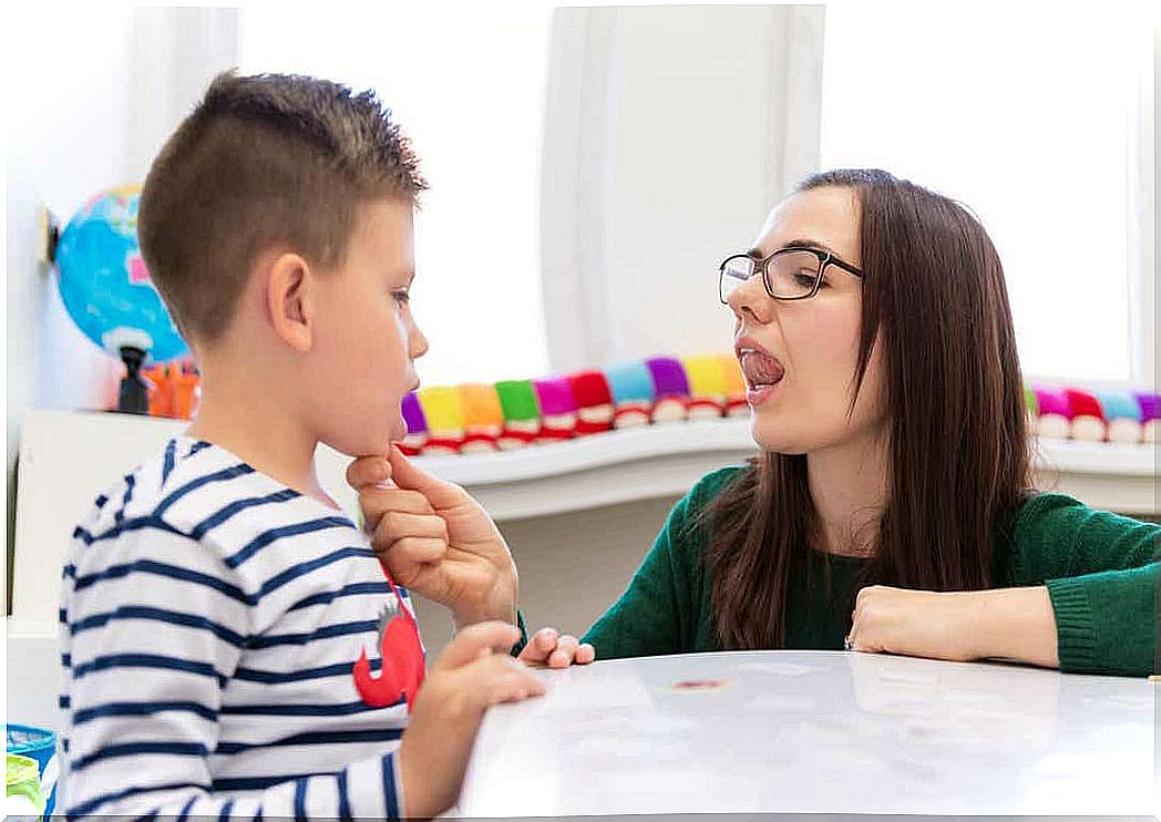 A speech therapist working with a little boy.