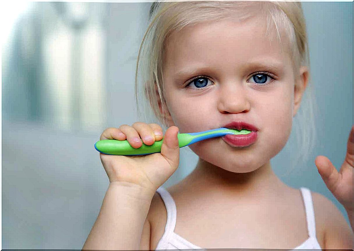 Girl brushing her teeth.