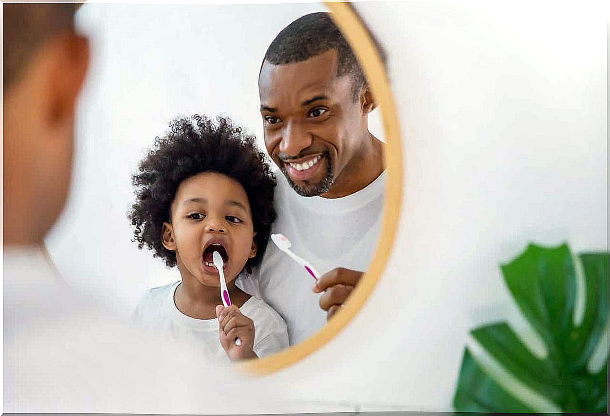 Dad brushes his teeth.