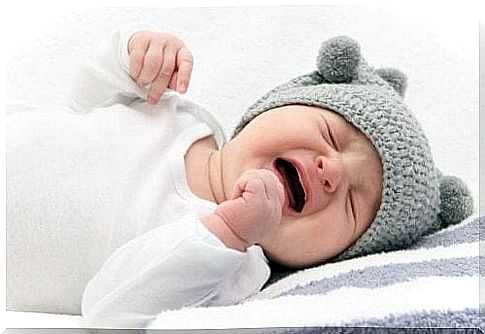 Crying baby with gray hat