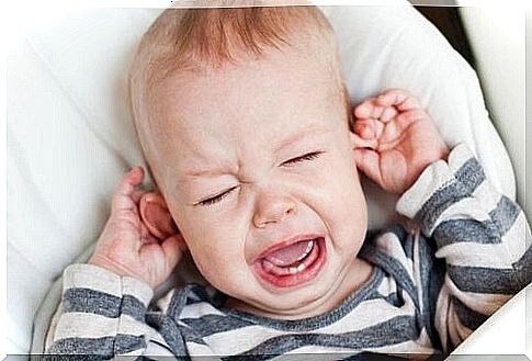 Child pulls his ears crying