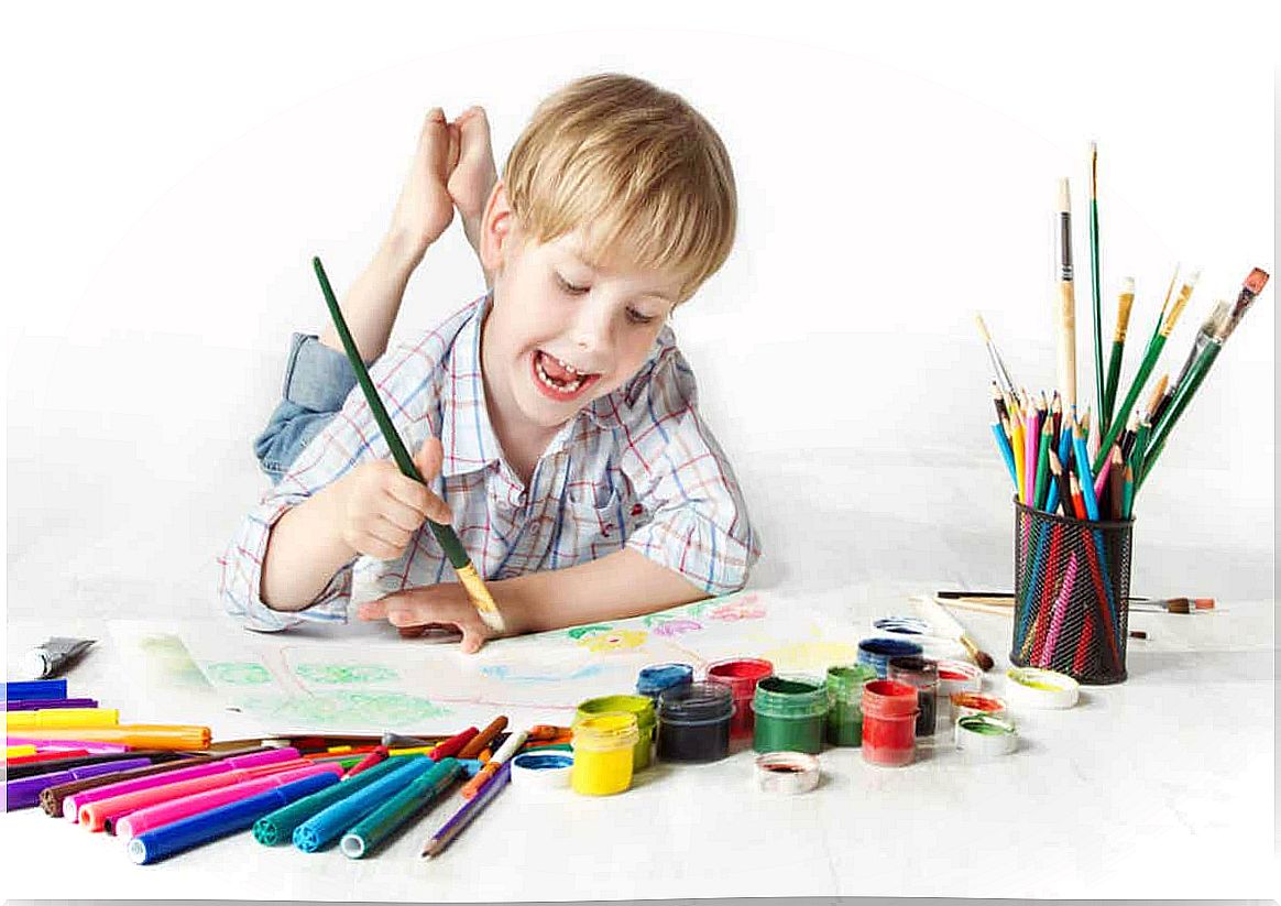 A child painting on the floor.