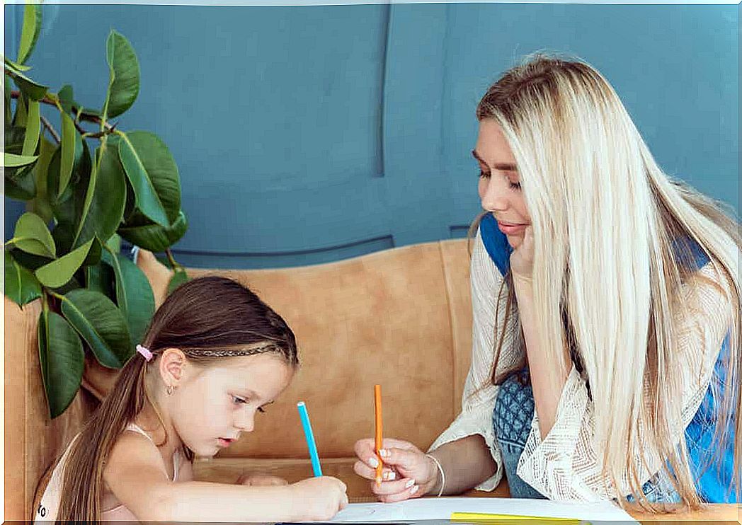 A mother and daughter drawing together.