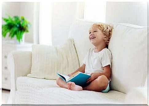 Boy sitting with a book on the couch