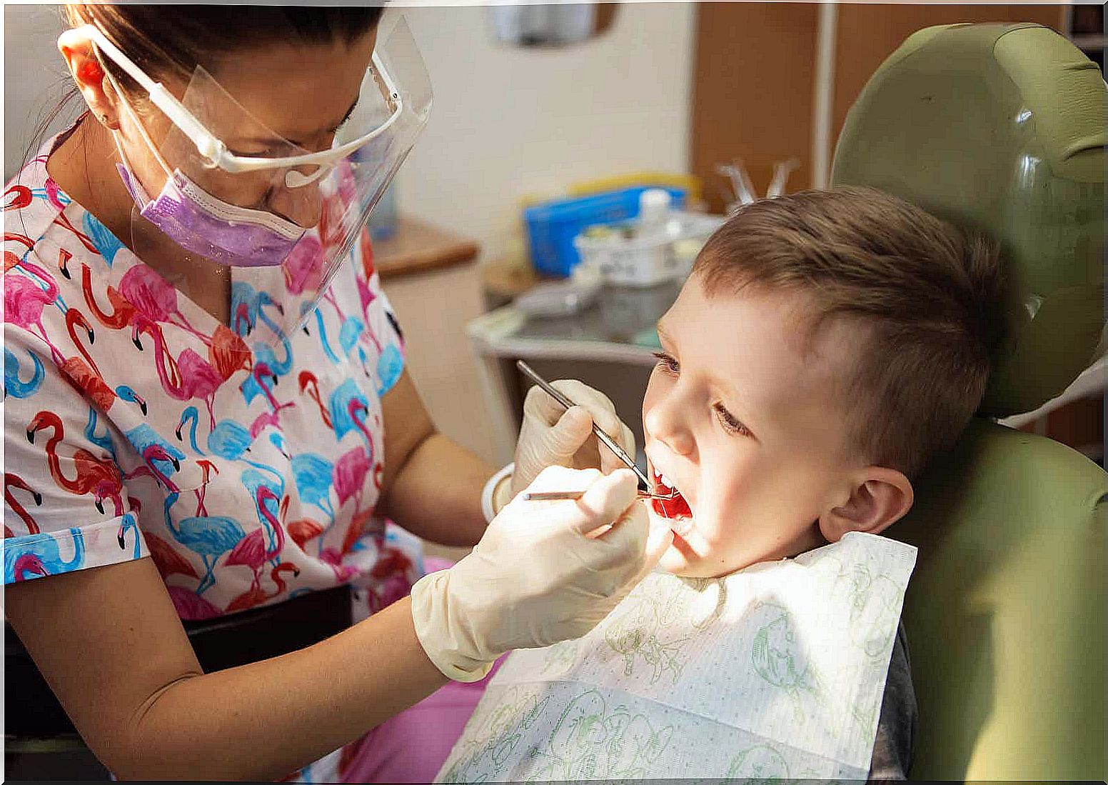 A dentist checking a boy with teeth grinding