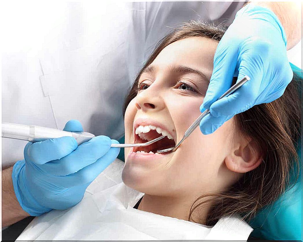 A dentist treating a young girl