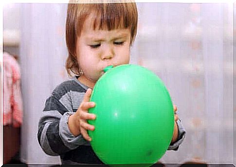 Child with a green balloon