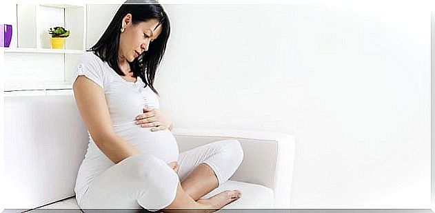 Pregnant woman on white couch