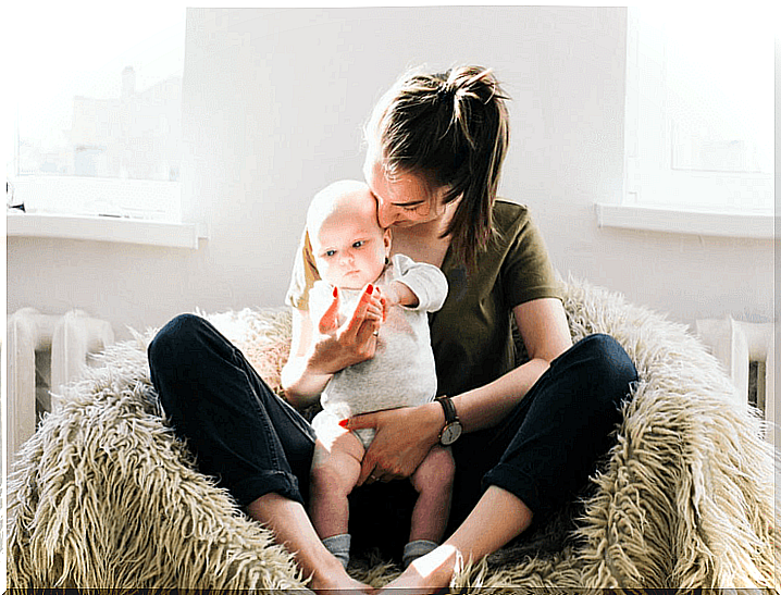 Mother hugs her baby