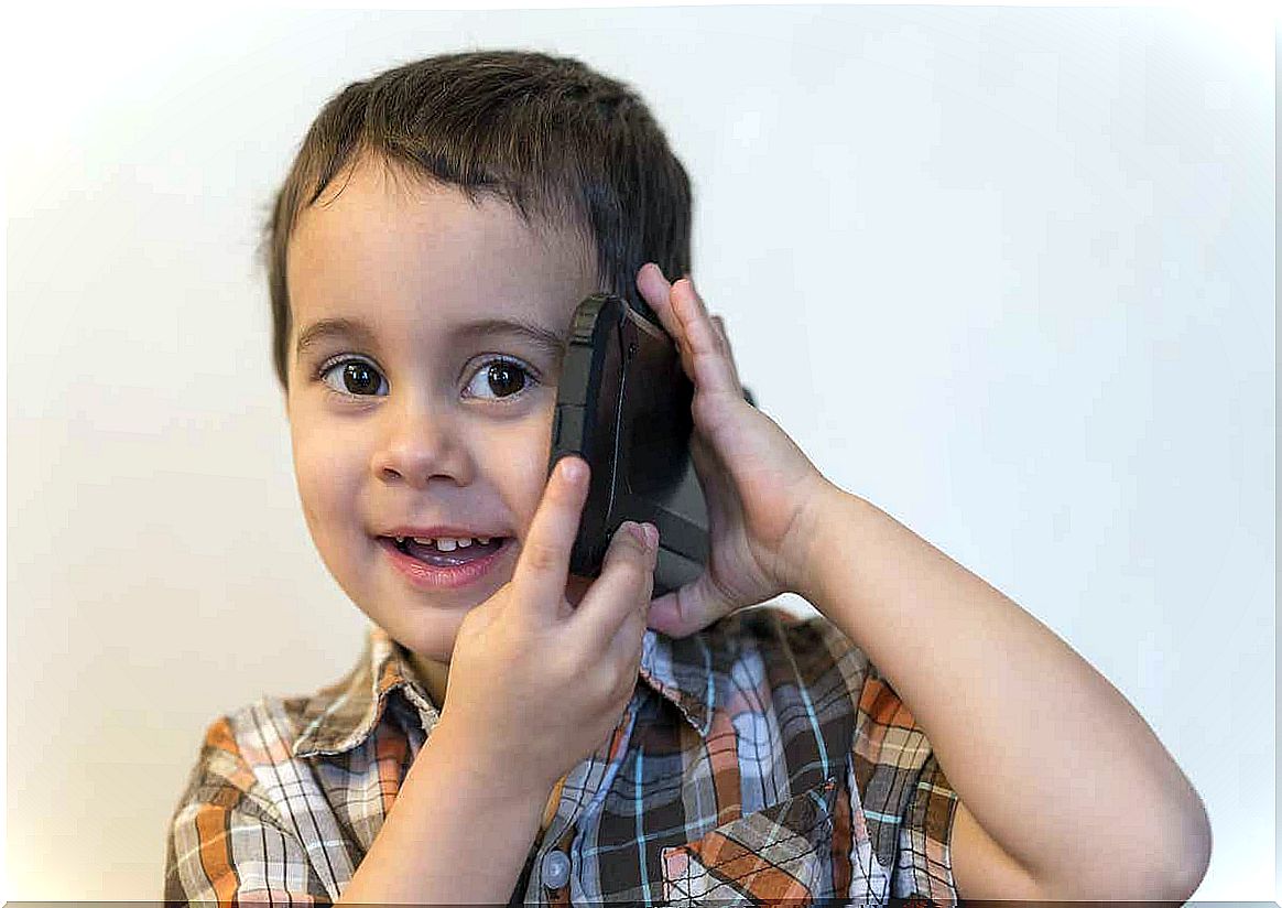 A child talking on a cell phone.