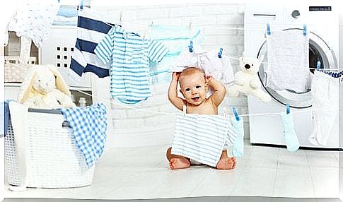 Child between garlands of clothes