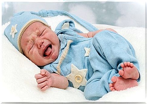 Crying baby in blue suit