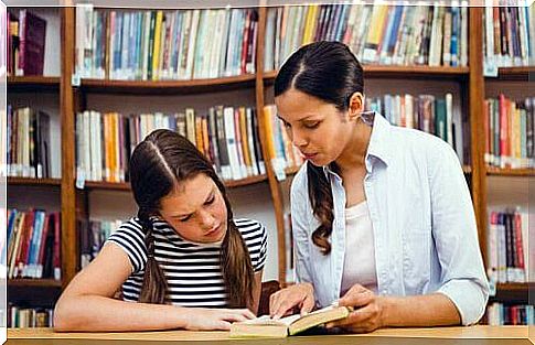 woman teaching girl