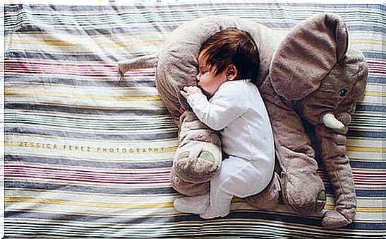 Baby with cuddly elephant